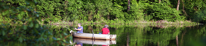 Two guys Fishing in a Lake on a Canoe