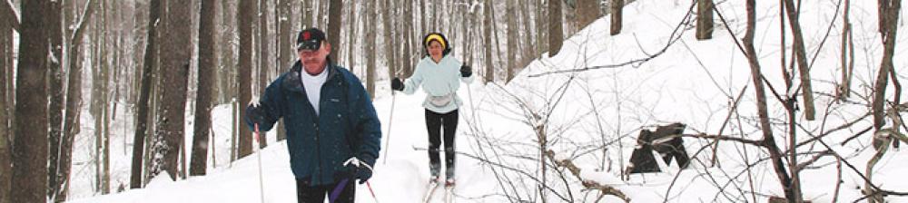 two people cross country skiing in winter