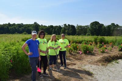 group photo of 4 women for day of caring in front of pollinator garden