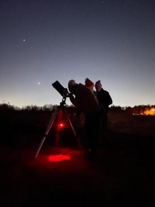 People using a telescope