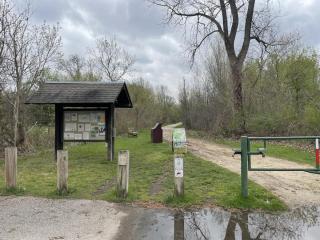 limestone trail on right; park kiosk on left; cloudy sky