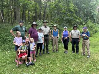 hikes gathered in a clearing for a photo
