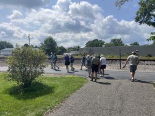 senior hikes on a sunny day with a blue sky