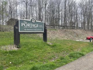 A green sign reads Portage Park District above green grass